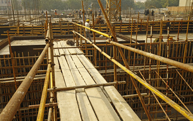 worker in the construction site making reinforcement metal frame