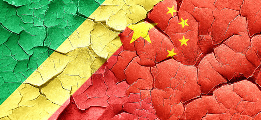 Fototapeta premium Congo flag with China flag on a grunge cracked wall