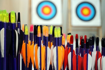 Archery arrows with targets in out of focus background