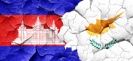 Cambodia flag with Cyprus flag on a grunge cracked wall