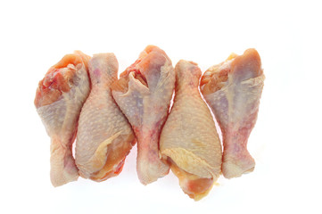 Raw chicken leg on a white background
