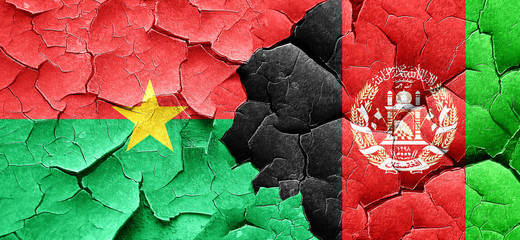 Burkina Faso flag with afghanistan flag on a grunge cracked wall