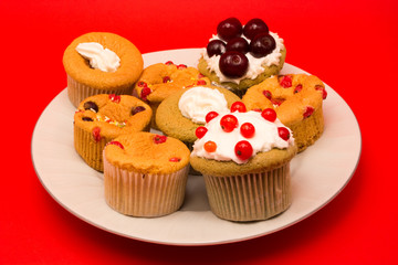 Sweet cupcakes with fress fruit on top of them