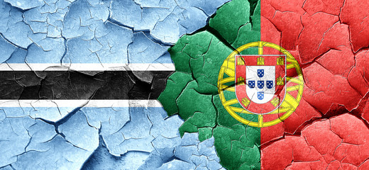 Botswana flag with Portugal flag on a grunge cracked wall