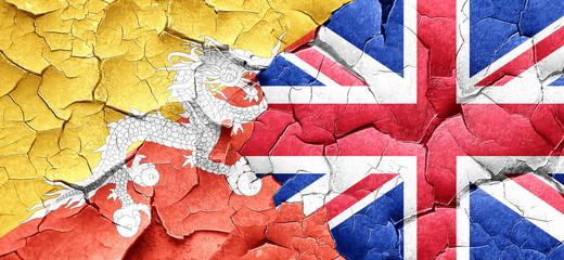 Bhutan flag with Great Britain flag on a grunge cracked wall