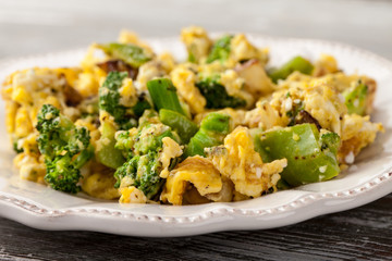 Scrambled eggs with broccoli, onions, and green bell peppers macro shot