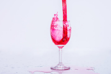 Red wine splash on white background.