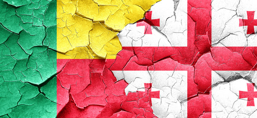 Benin flag with Georgia flag on a grunge cracked wall
