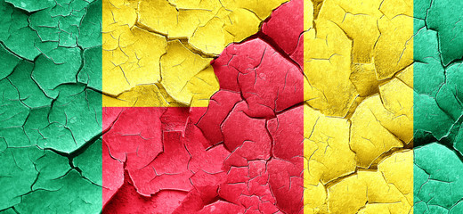 Benin flag with Guinea flag on a grunge cracked wall