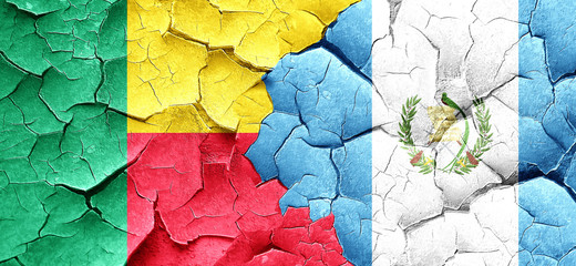 Benin flag with Guatemala flag on a grunge cracked wall