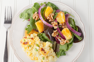 Walnut orange spinach vinaigrette salad with cauliflower mac and cheese top view