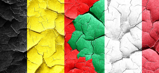 Belgium flag with Italy flag on a grunge cracked wall