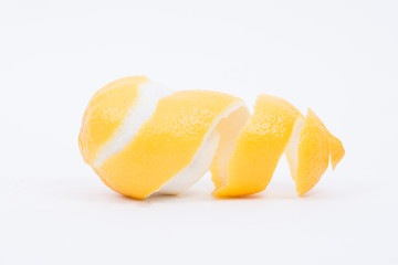 Yellow lemon with peeled skin on white background.