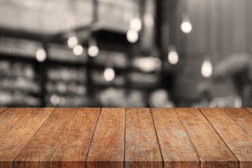 Wooden tabletop with sepia coffee shop blurred background