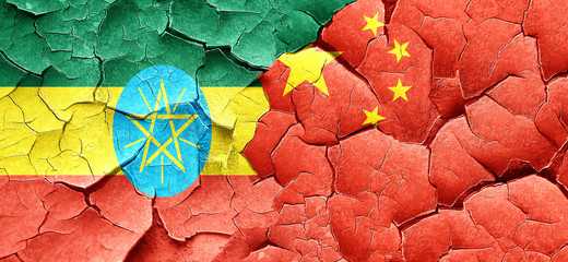 Ethiopia flag with China flag on a grunge cracked wall