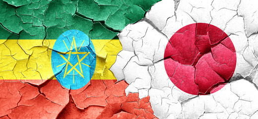 Ethiopia flag with Japan flag on a grunge cracked wall