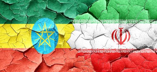 Ethiopia flag with Iran flag on a grunge cracked wall