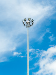 High voltage spotlight pole on sky backgroud