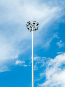 High voltage spotlight pole on sky backgroud
