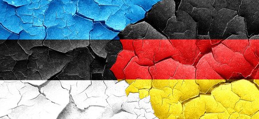 estonia flag with Germany flag on a grunge cracked wall