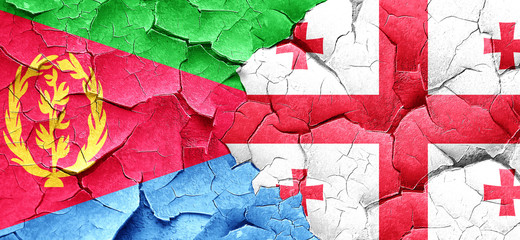 Eritrea flag with Georgia flag on a grunge cracked wall