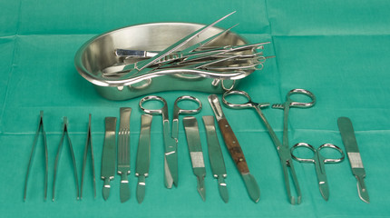 Medical instruments on green fabric
