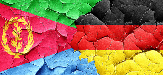Eritrea flag with Germany flag on a grunge cracked wall