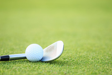 Golf ball on green grass in course