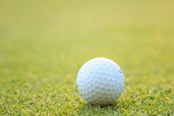 Golf ball on green grass in course