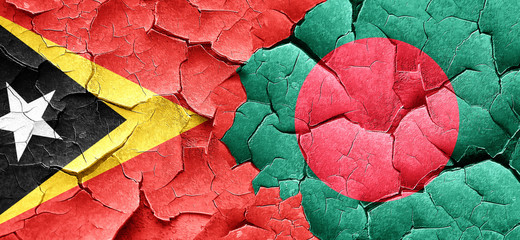 east timor flag with Bangladesh flag on a grunge cracked wall