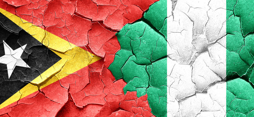 east timor flag with Nigeria flag on a grunge cracked wall