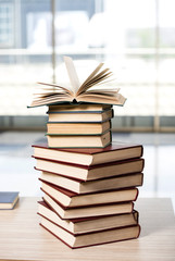 Stack of books arranged the office desk