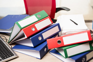 Stacks of office binders on desk