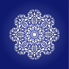 Die cut paper card with cutout mandala ornament.