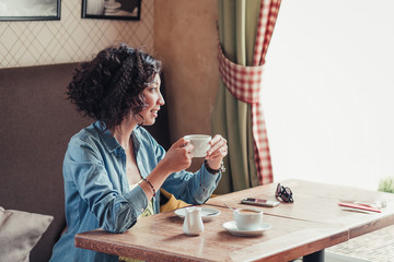 Curly hair hipster Woman in casual jeans clothes sitting in a ca