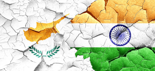 Cyprus flag with India flag on a grunge cracked wall