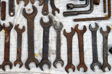 Wrenches in several different sizes on natural wooden background