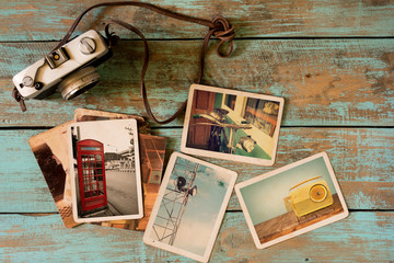 Retro technology instant photo album on wood table. paper photo of vintage camera - vintage and retro style