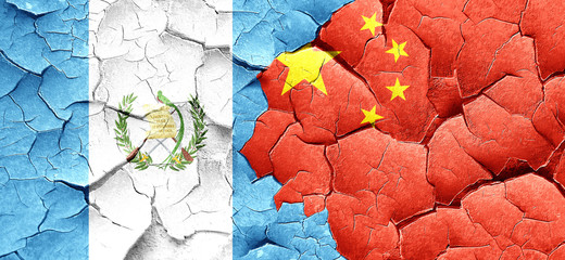 guatemala flag with China flag on a grunge cracked wall