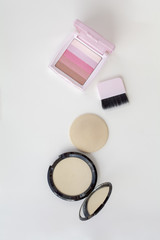 makeup powder and pink blusher