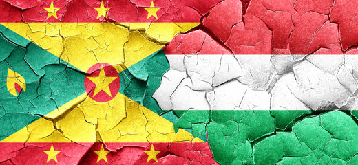 Grenada flag with Hungary flag on a grunge cracked wall