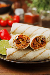 Burritos wraps with meat, beans and vegetables.