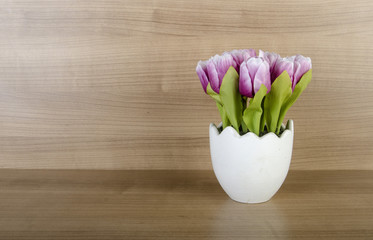 Tulip flowers against wooden background