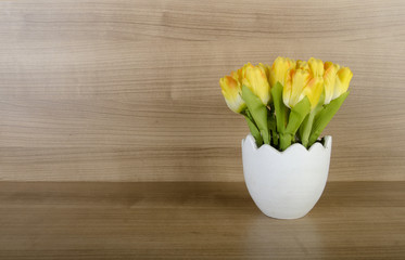 Tulip flowers against wooden background