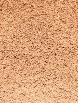 Painted textured surface of a wall covered with terracotta stucco background