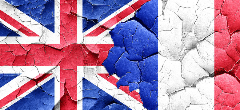 Great britain flag with France flag on a grunge cracked wall