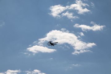 Small old airplane in blue sky in a day
