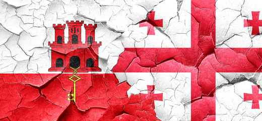 gibraltar flag with Georgia flag on a grunge cracked wall