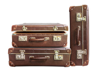 Open and two closed vintage brown suitcase on white background