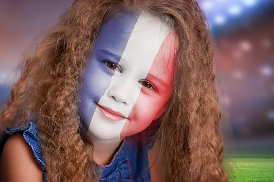 Soccer fan little girl portrait with France flag on face